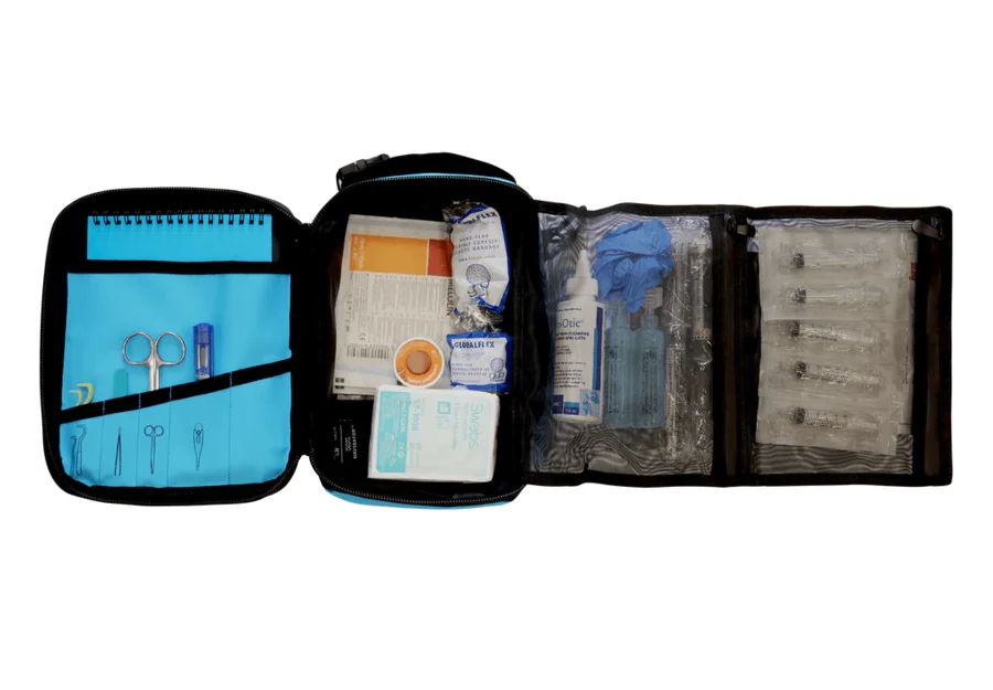 The Pet First Aid Kit opened out, showing its instruments, bandages, syringes and quick-reference guide